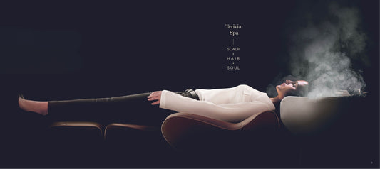 Person lying on a Terivia spa bed with steam rising, indicating a relaxing spa experience.